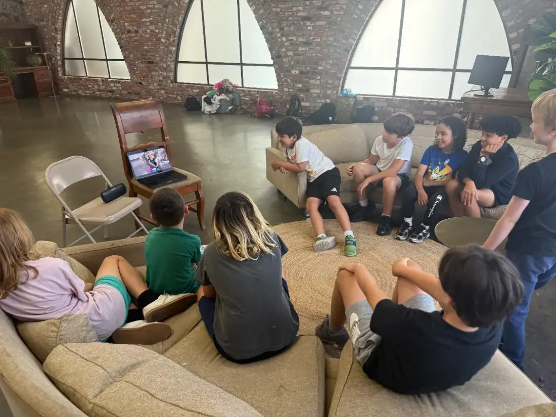 An after-school story club watching a scene back together on the sofa