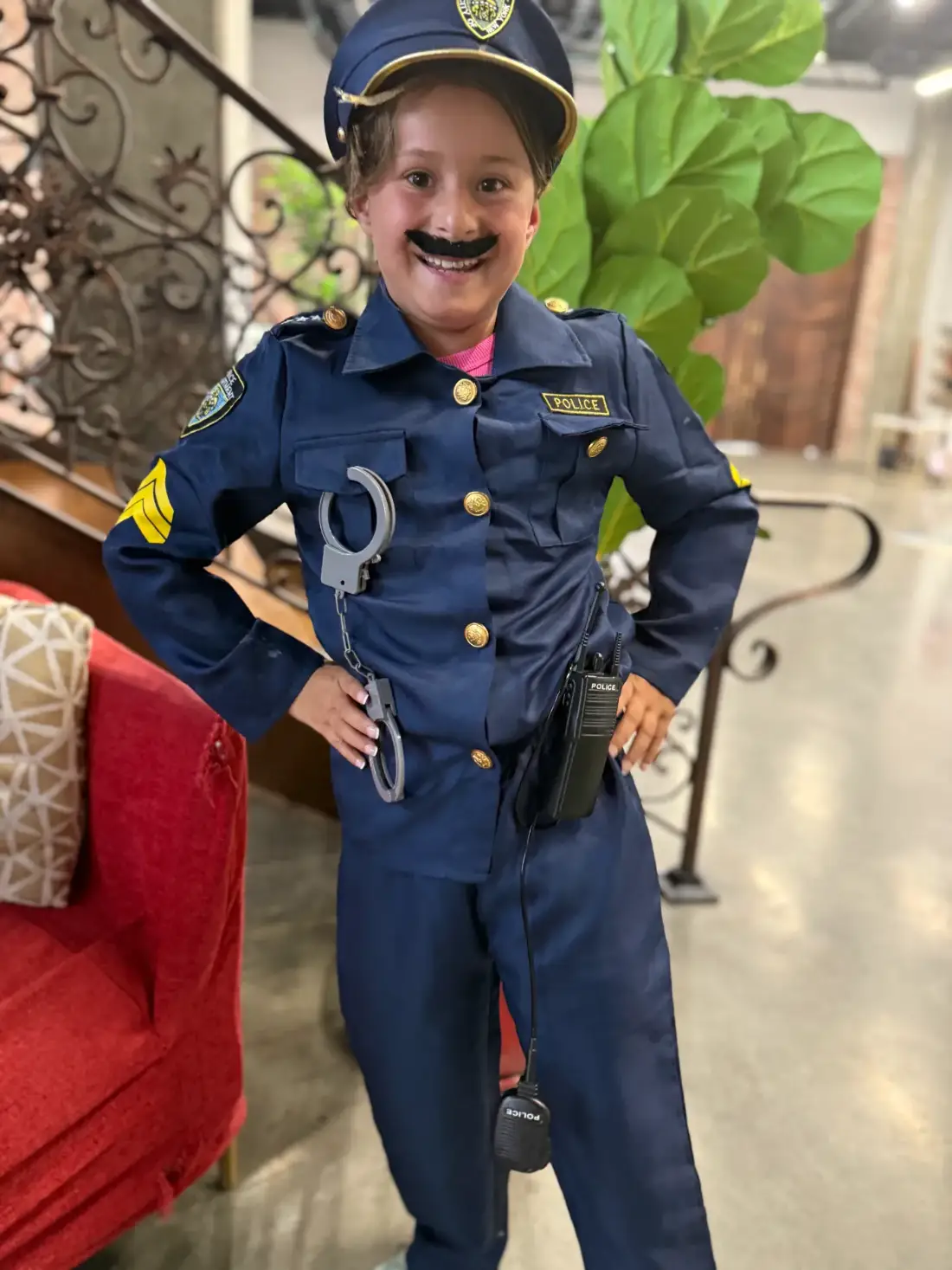 A camper in a police costume and moustache, in character