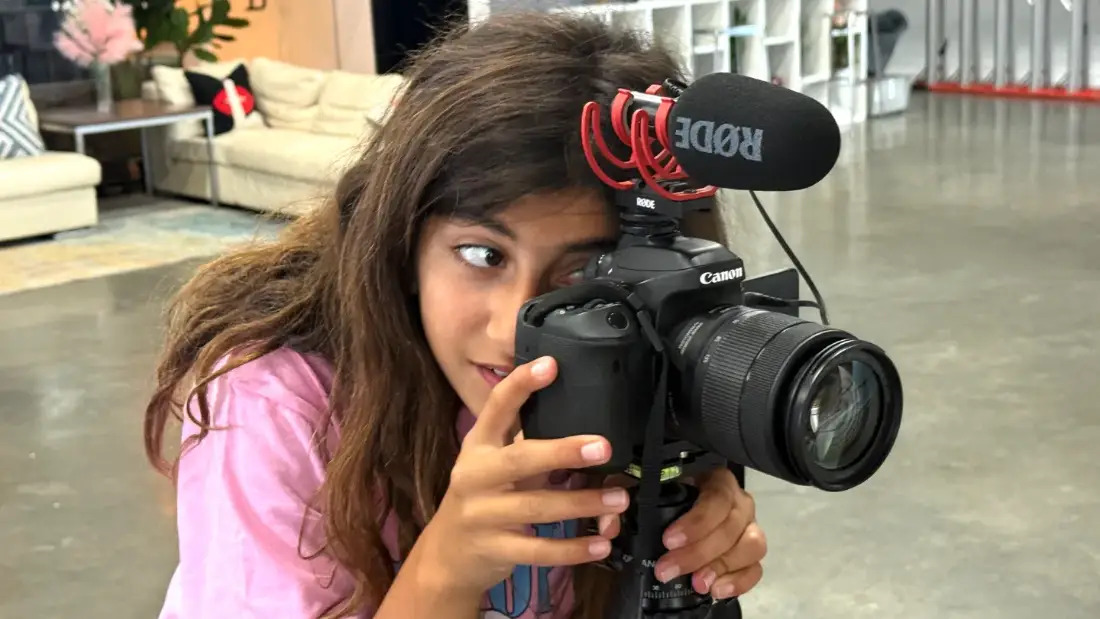 A camper lining up a shot on a Canon with a shotgun mic