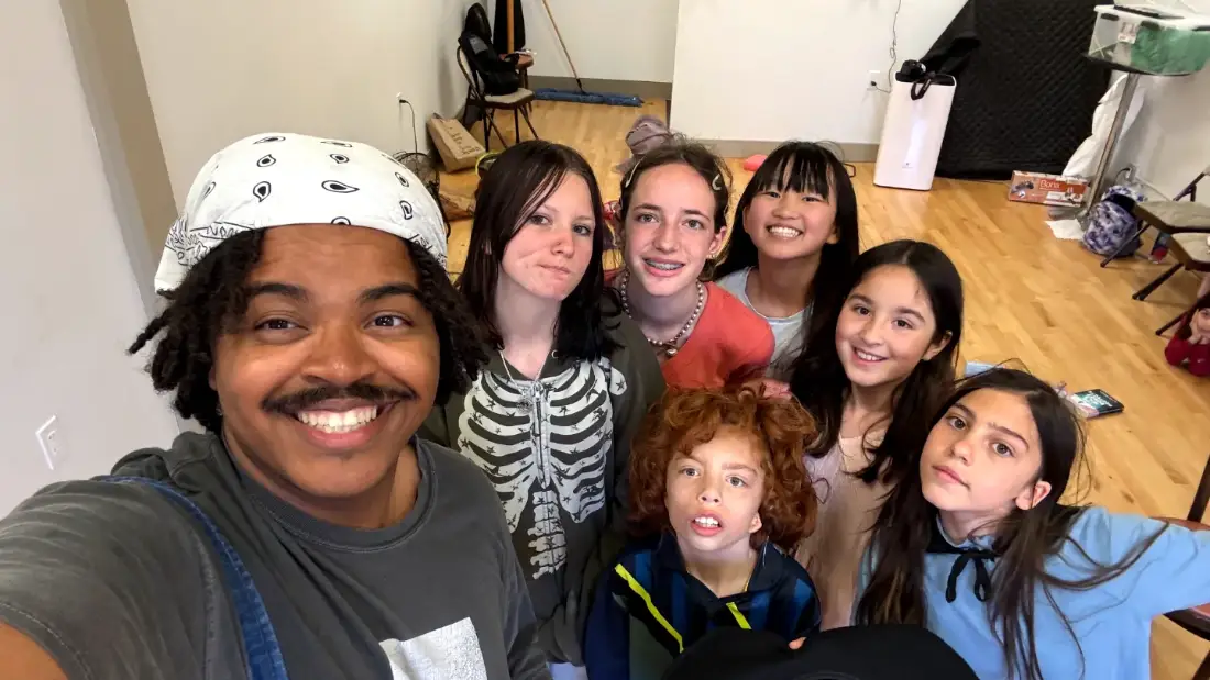 An instructor and his Sunday class crowding into a selfie